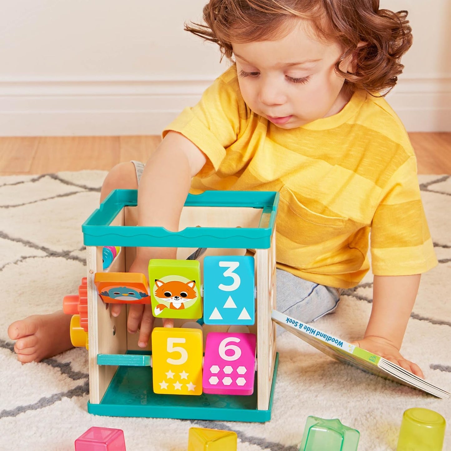 B. toys – Activity Cube – Educational Storybook Included – Wooden Shape Sorter, Bead Maze, Animal Tiles – Top Flips for Compact Storage – 12+ Months – Lil' Learning Cube